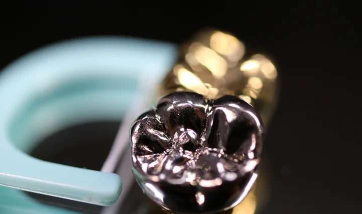 Close-up of a dental alloy showing a metallic dental crown